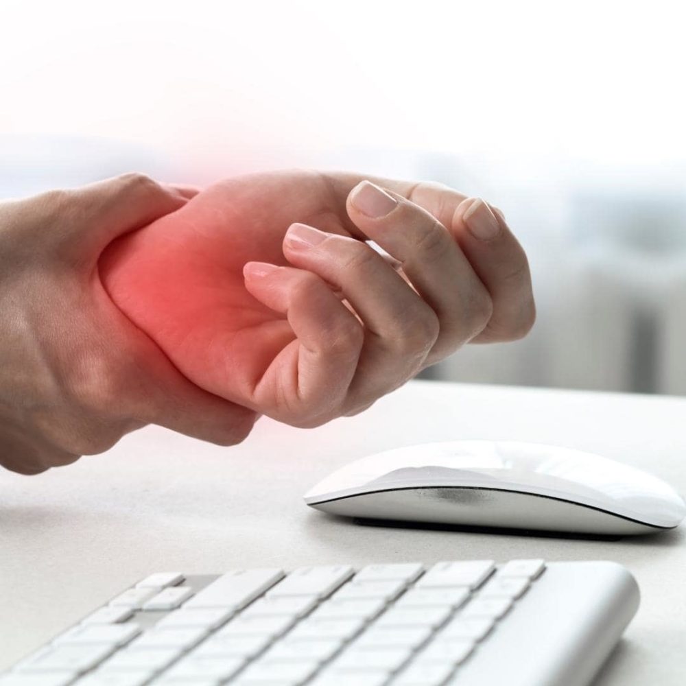 image of remote worker suffering from carpal tunnel syndrome