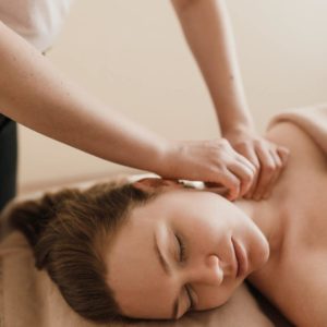 Photo of female presenting person getting lymphatic drainage massage after plastic surgery