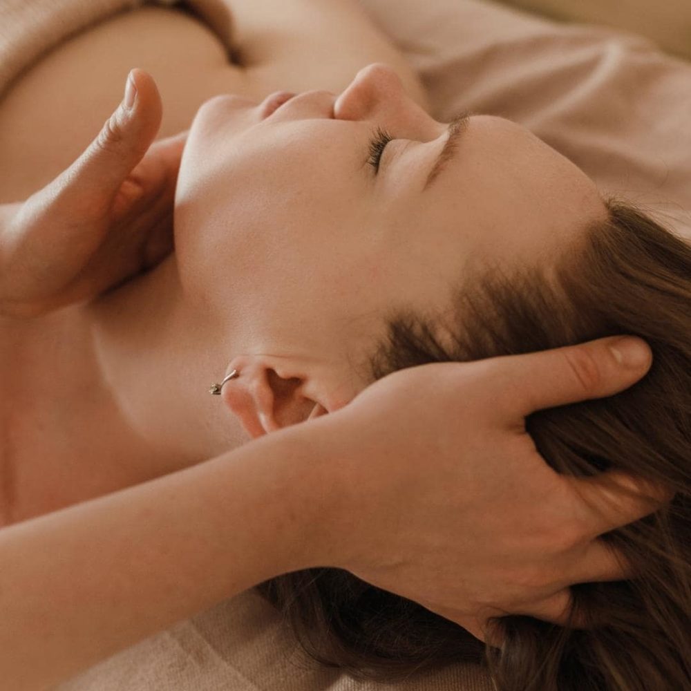 Photo of female presenting person receiving an oncology massage