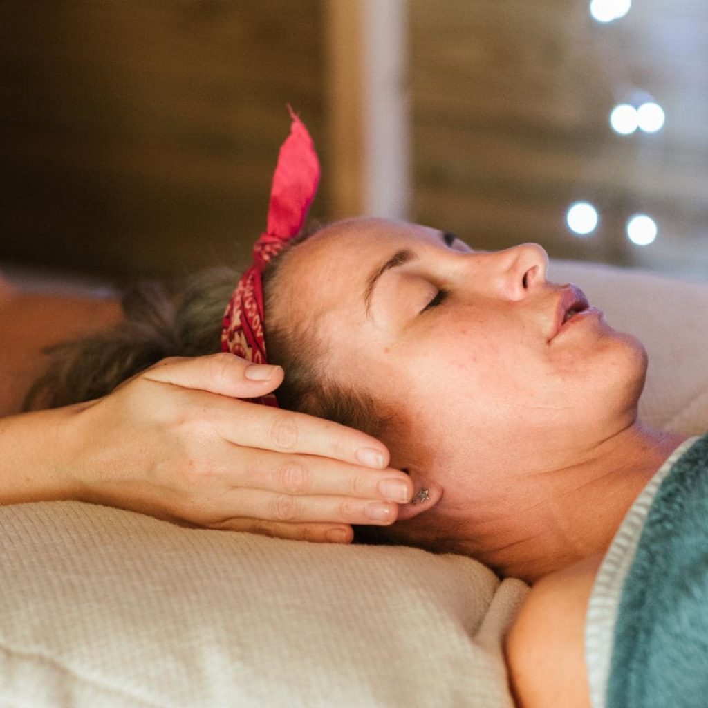 Photo of woman with red bandana getting an oncology massage