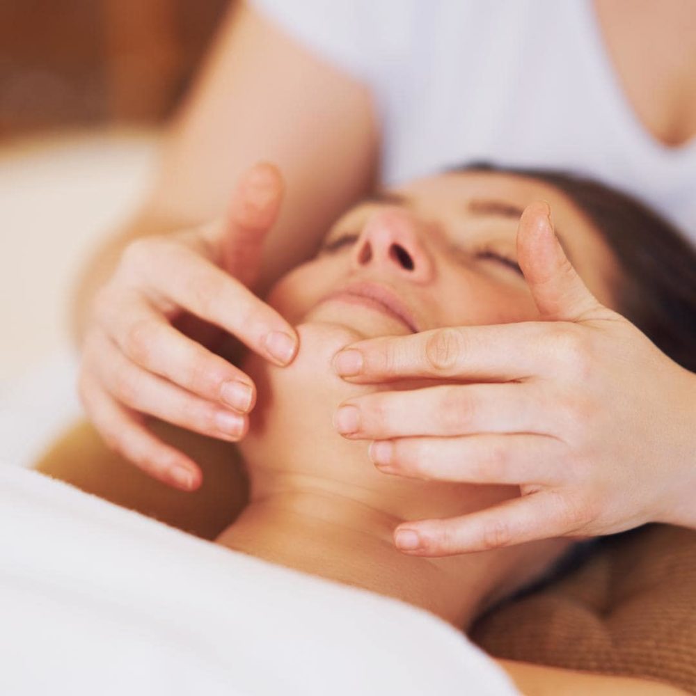 Photo of woman getting a Manual Lymphatic Drainage after a facelift.