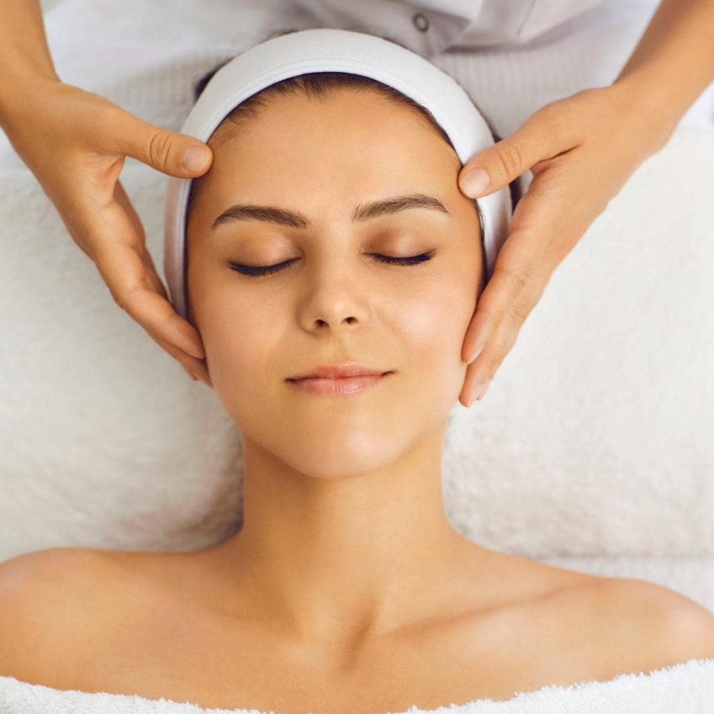 Photo of a female presenting person getting a lymphatic drainage massage in post-plastic surgery care